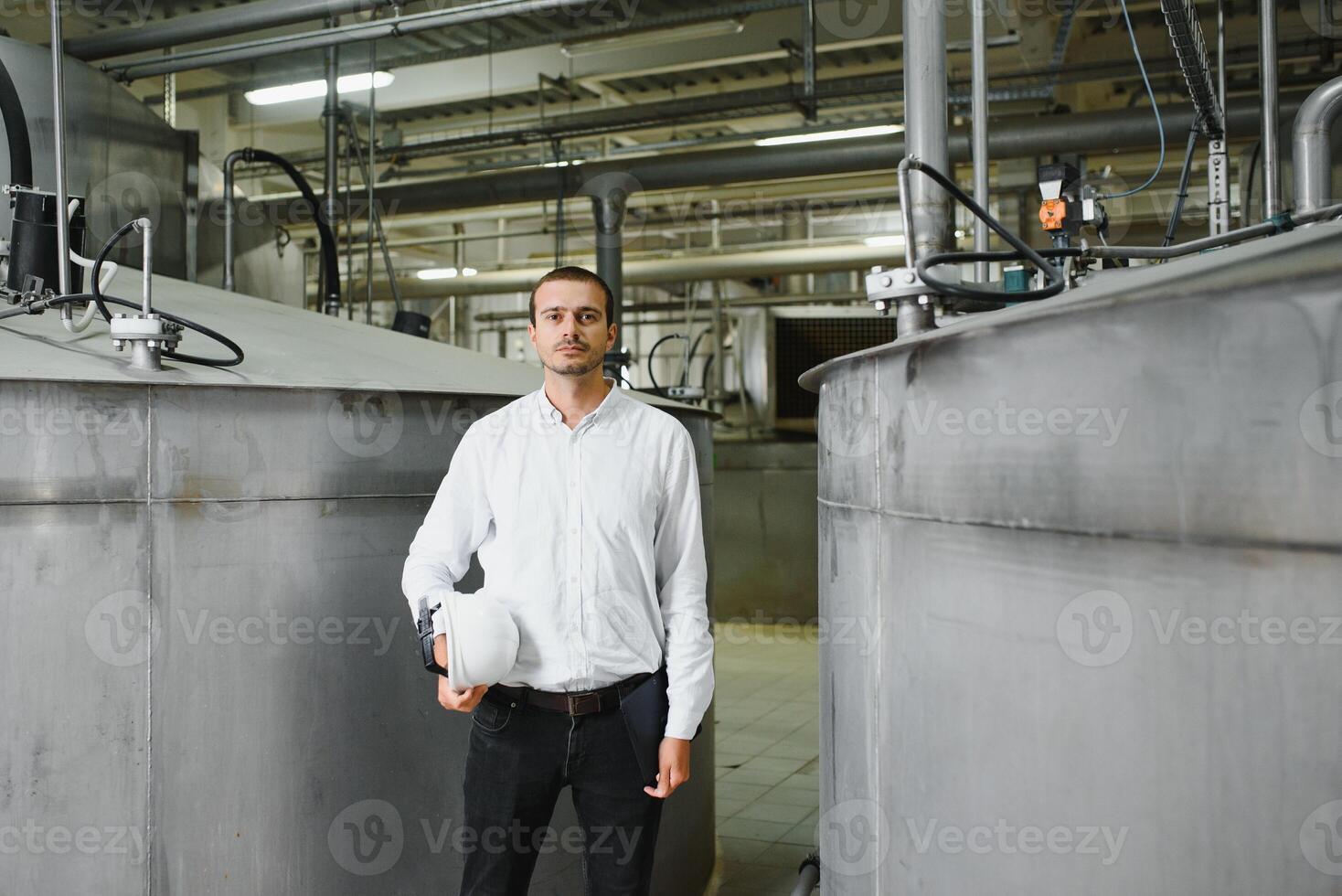 happy male industrial technician inside a factory photo