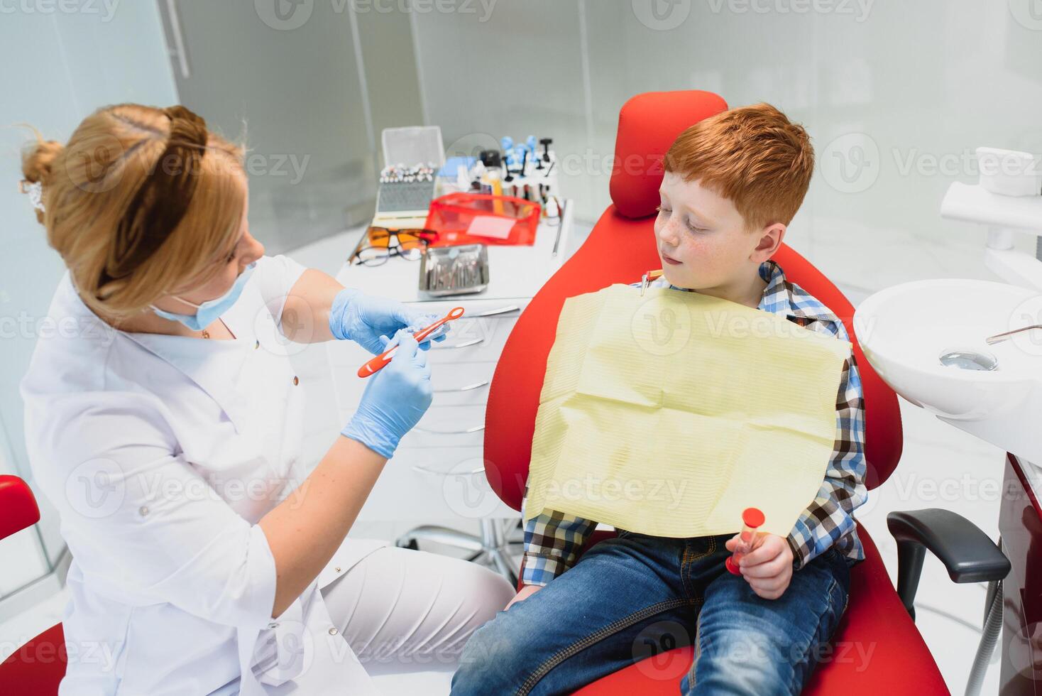 Female dentist and child in a dentist office photo