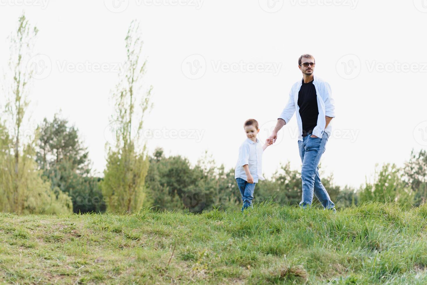 father and son have fun together in nature. Father and son playing. People having fun outdoors. Concept of friendly family. photo