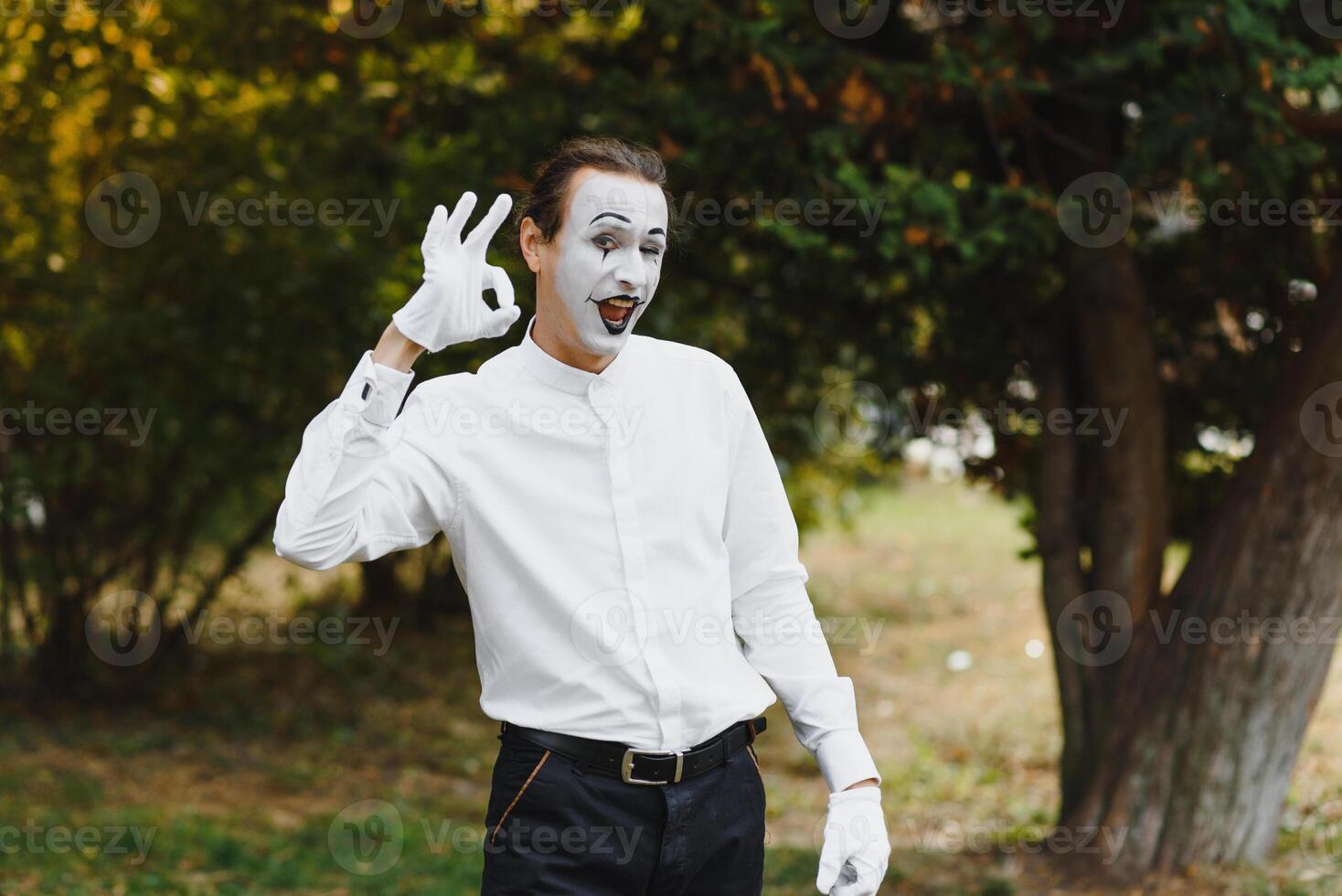 young Funny mime shows something. photo