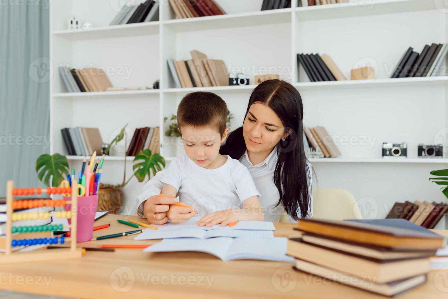 Portrait of pretty tutor and diligent pupil looking at each other while communicating photo