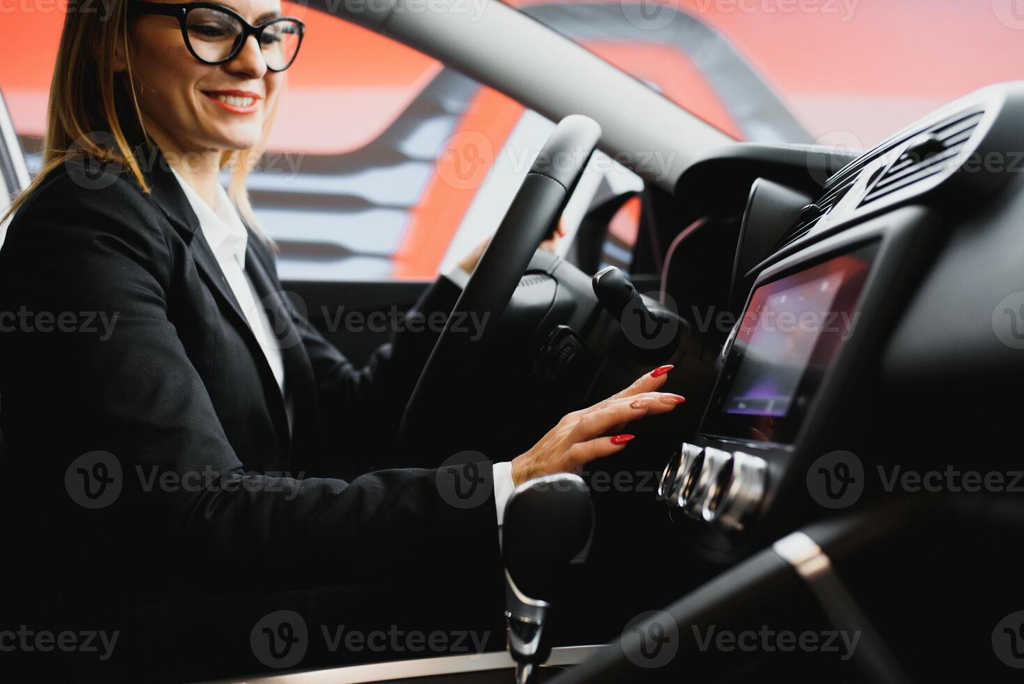 Young business woman driving in her car to work. Successful business concept. business woman driving photo