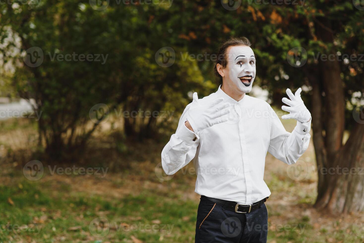 young Funny mime shows something. photo