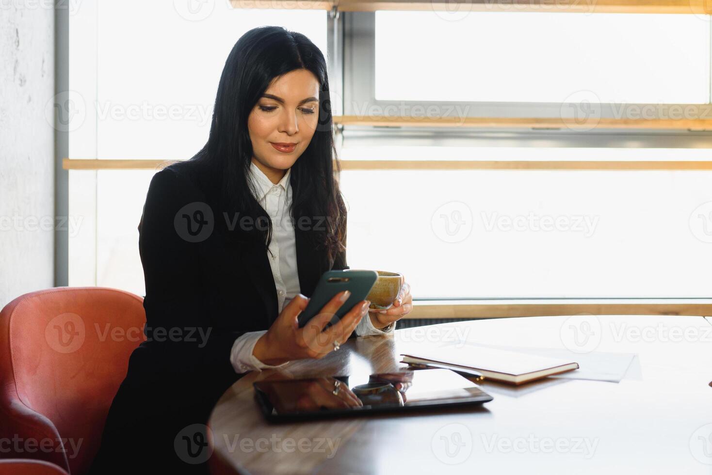 Cute commercial business corporate representative woman model brunette smiling in large building hall lobby photo