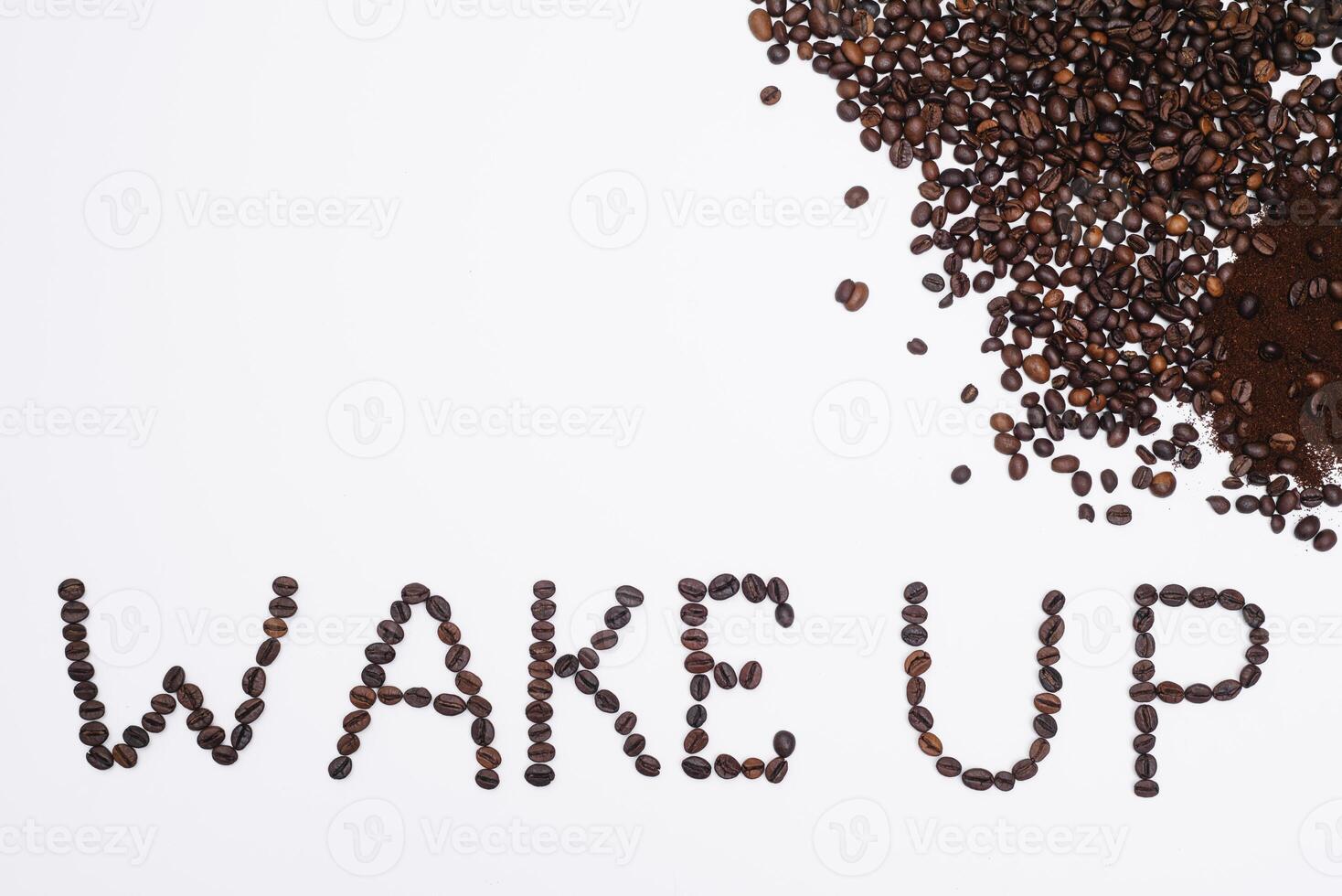 Words wake up from coffee beans isolated on white background photo