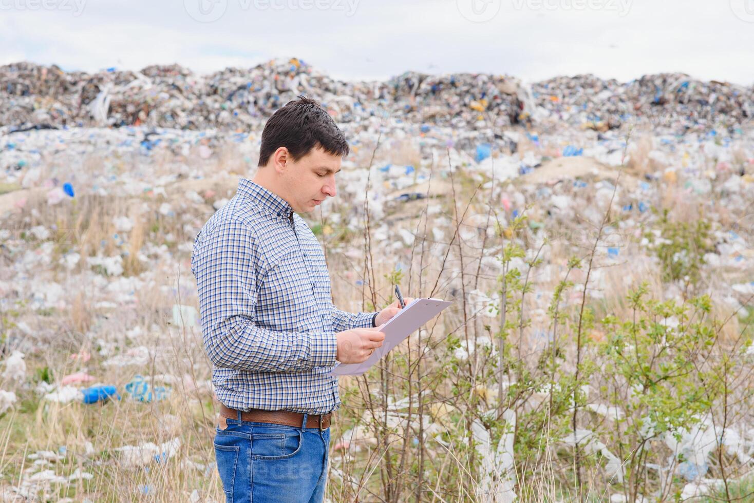 Nature conservation concept. A man studies the pollution of nature. Keeping the environment clean. Ecological problems. Recycling photo