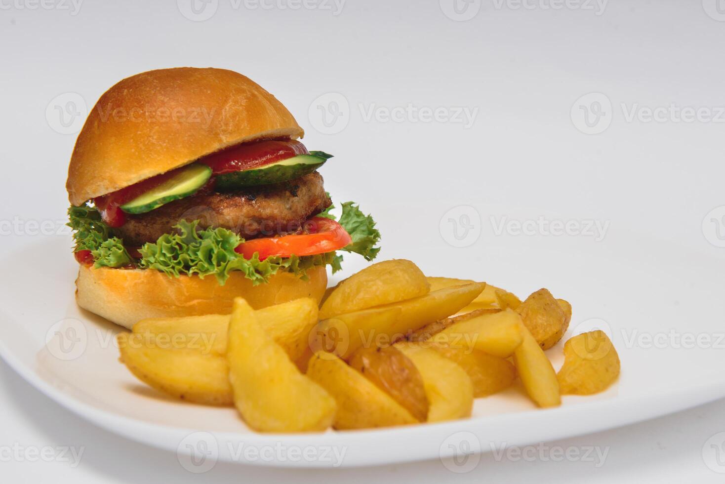 tasty hamburger, French fries and chili sauce on white plate, Fast food with copy space photo