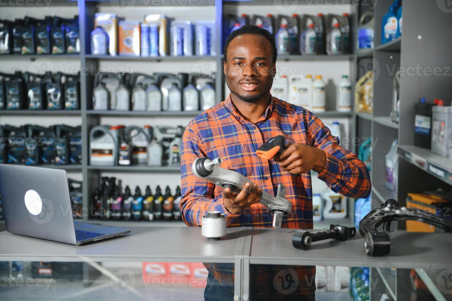 Portrait of a handsome salesman in an auto parts store. The concept of car repair photo