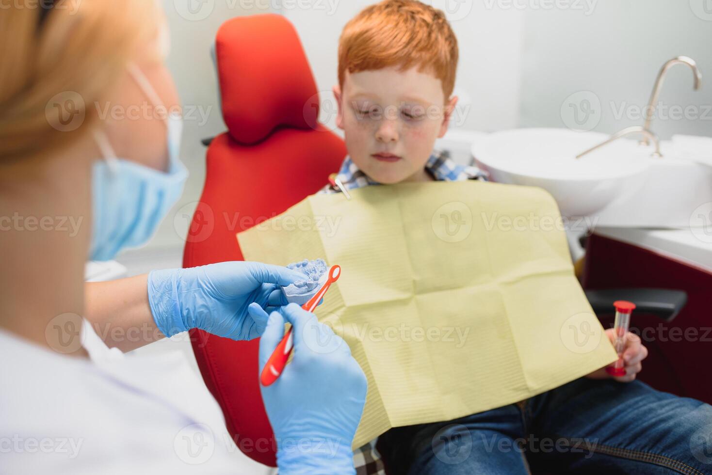 Female dentist and child in a dentist office photo