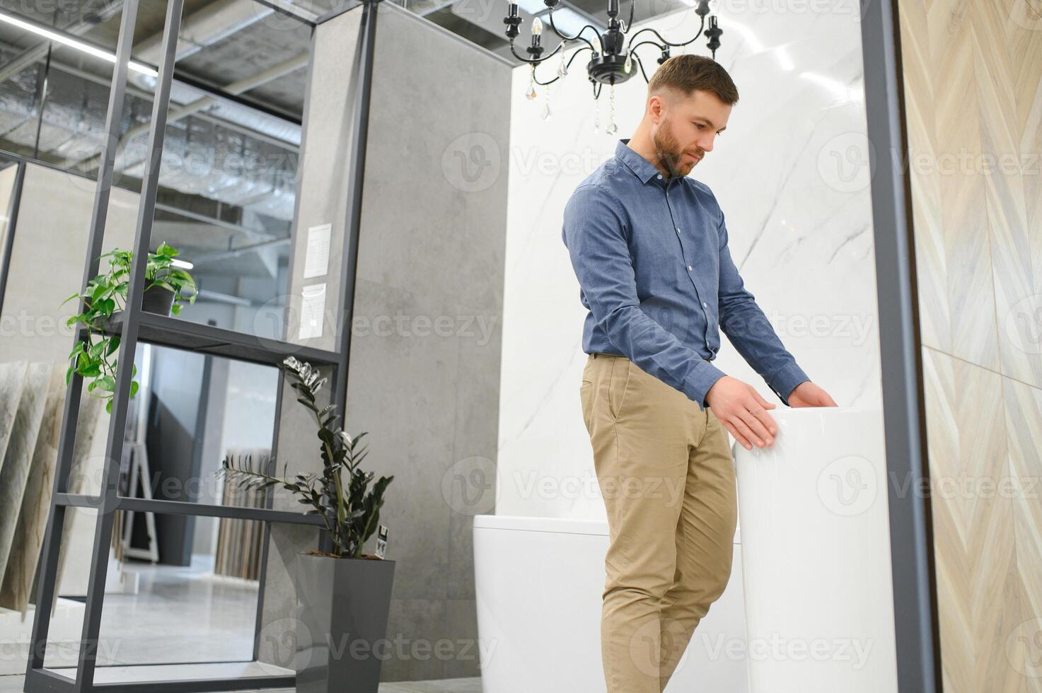 Choosing bath. Man in the store of goods for the home photo