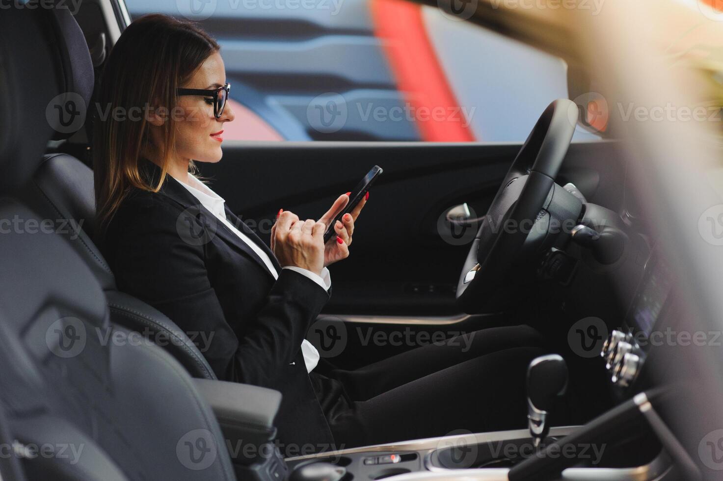 auto business, car sale, consumerism and people concept - happy woman taking car key from dealer in auto show or salon. photo