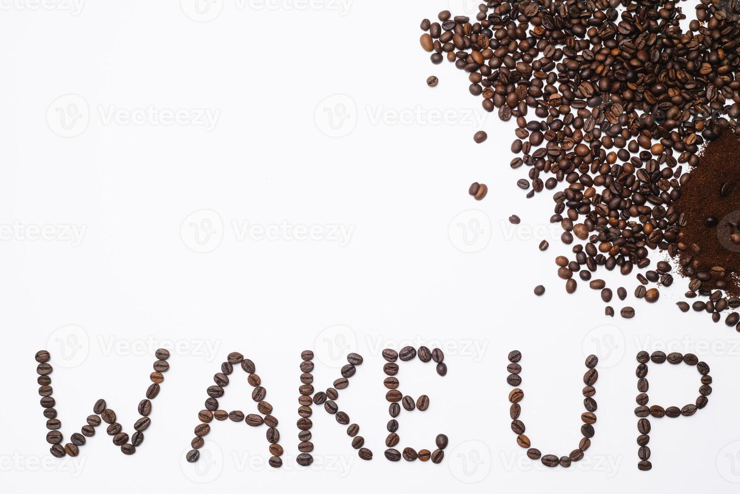 Words wake up from coffee beans isolated on white background photo