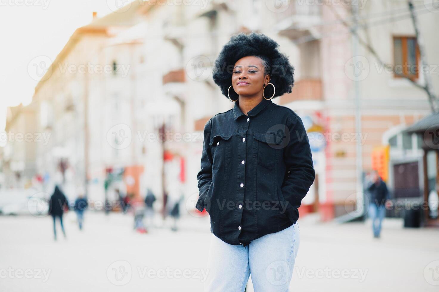 Outdoor close up portrait of young cute happy smiling african american woman with afro hairstyle. photo