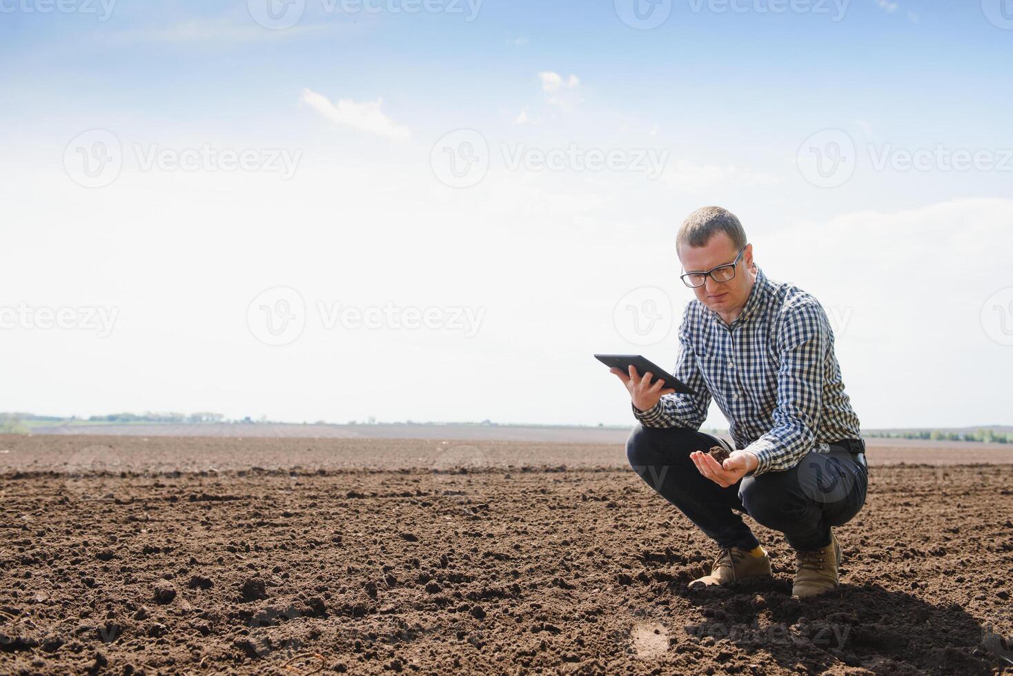 eco-activist at the landfill of used car tires calculates environmental damage. Nature conservation concept photo