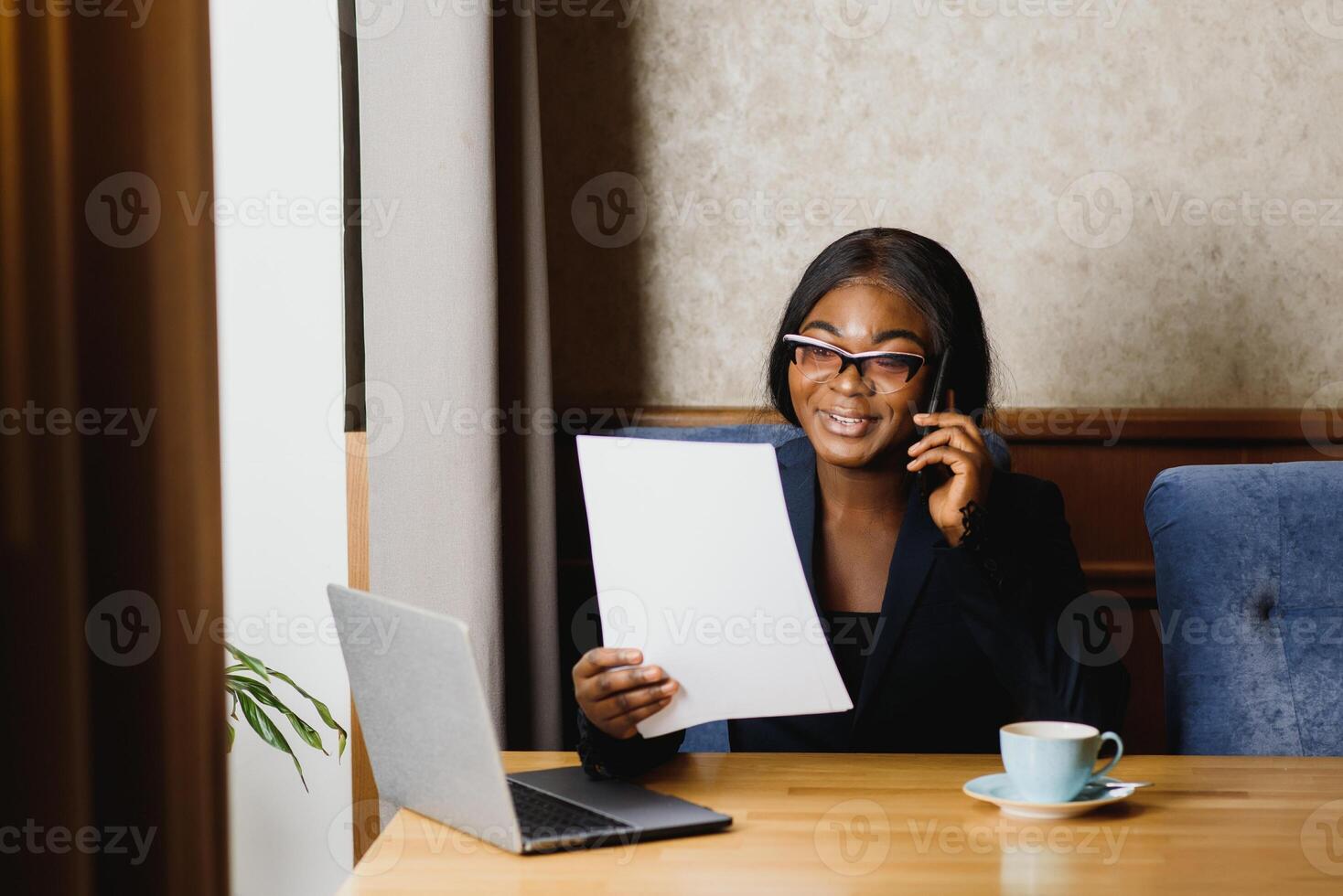happy young african american businesswoman using computer in office photo