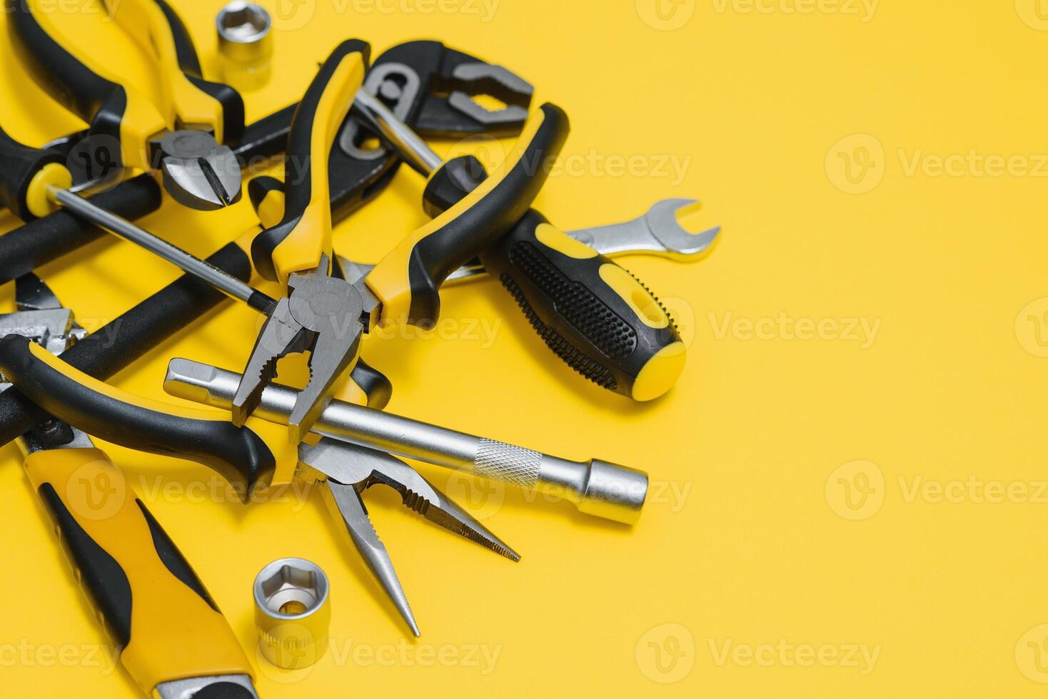 Carpenter tools set on yellow background, top view. photo