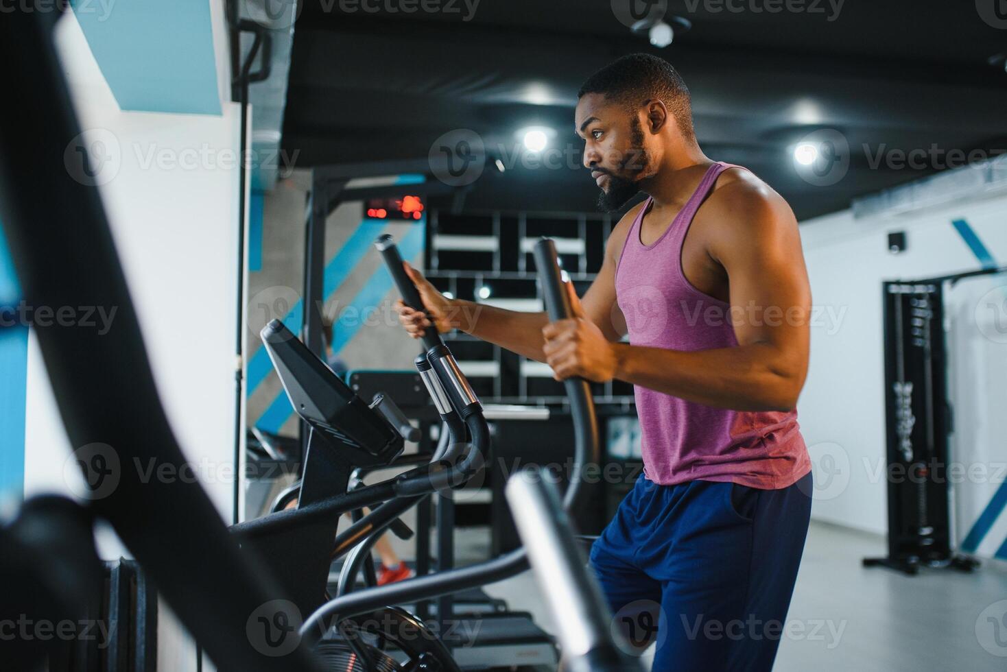 Weight training African doing bodybuilding in gym. photo