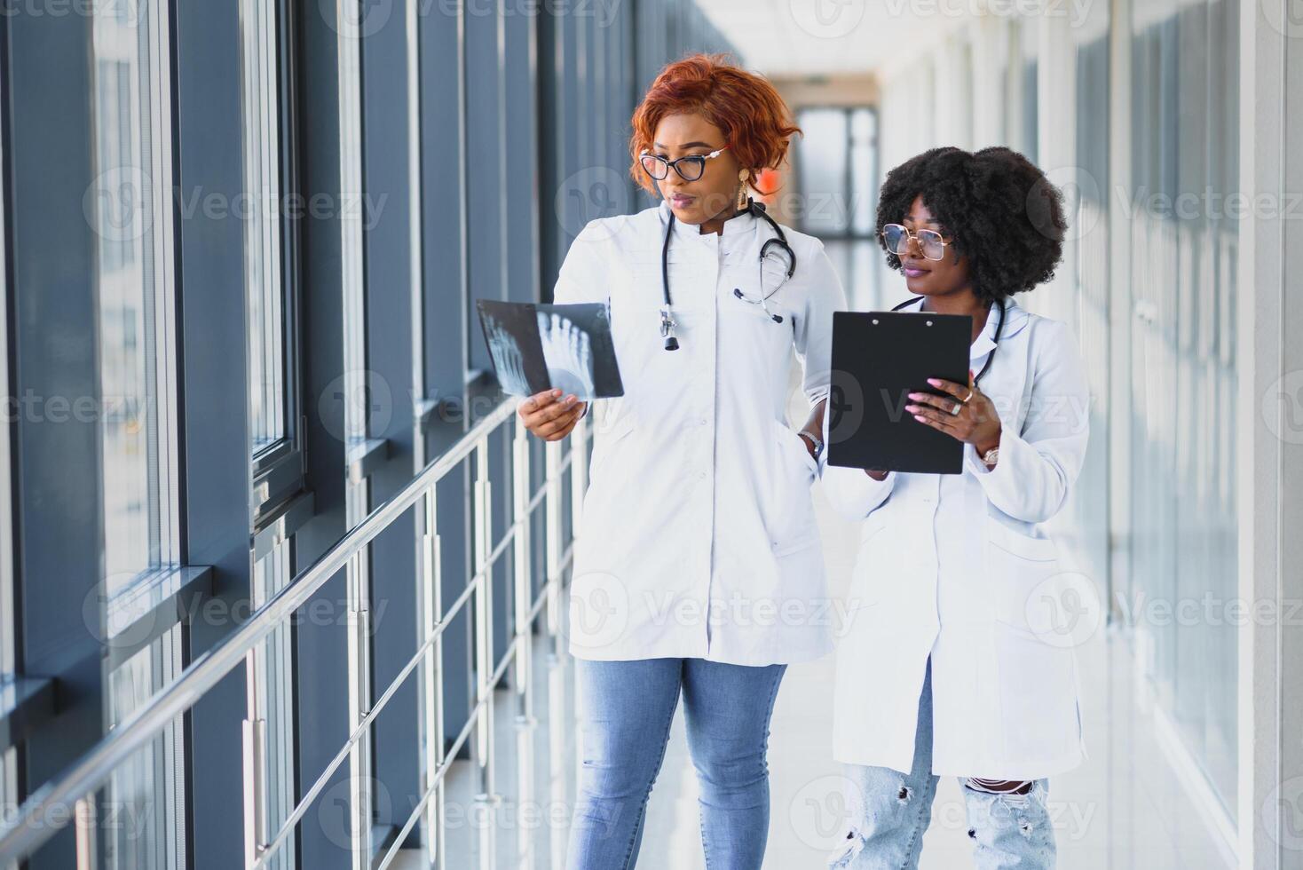 successful african american medical workers studying patient's x-ray photo