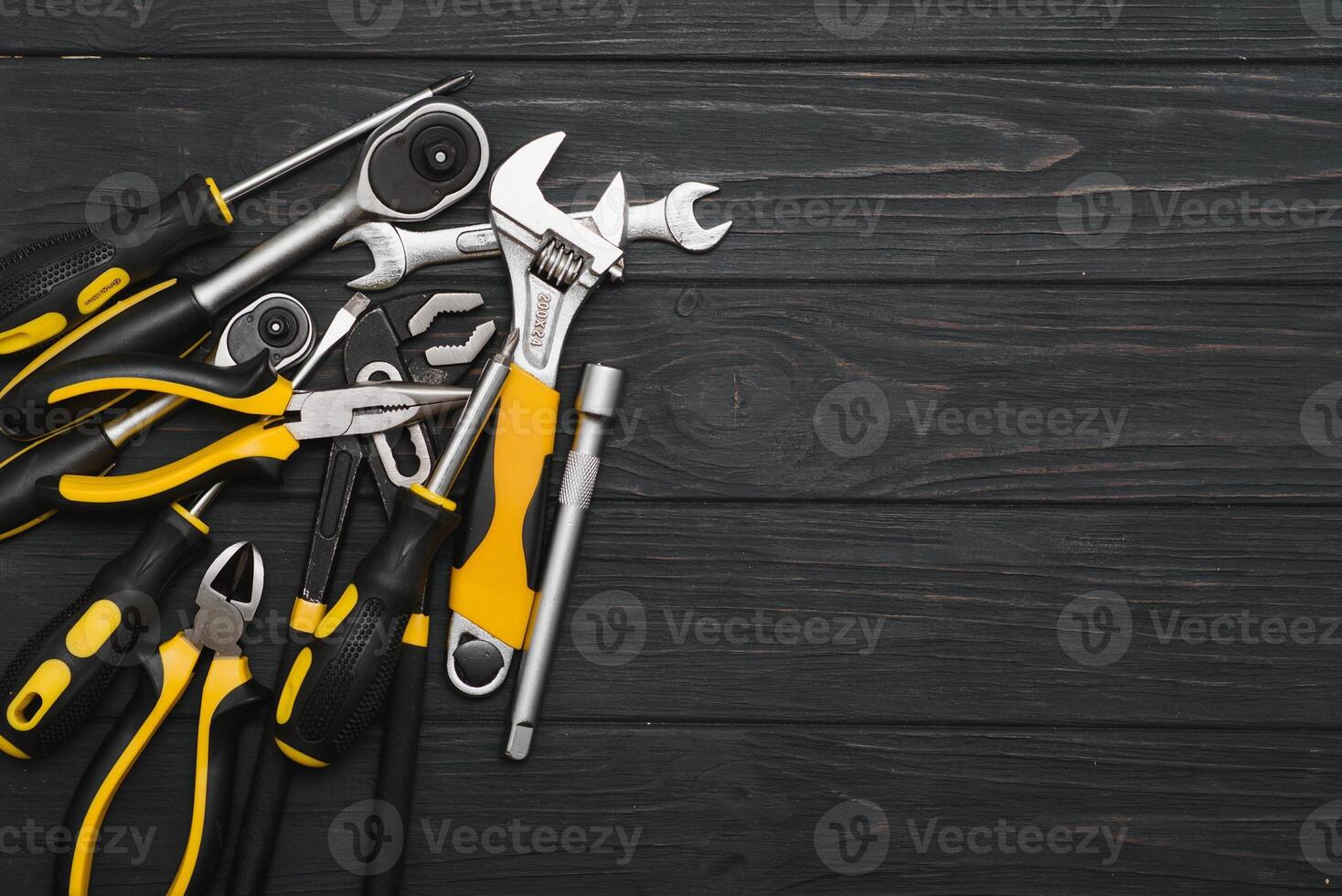 Set of assorted work carpentry and locksmith tools on a dark wooden background with copy space photo