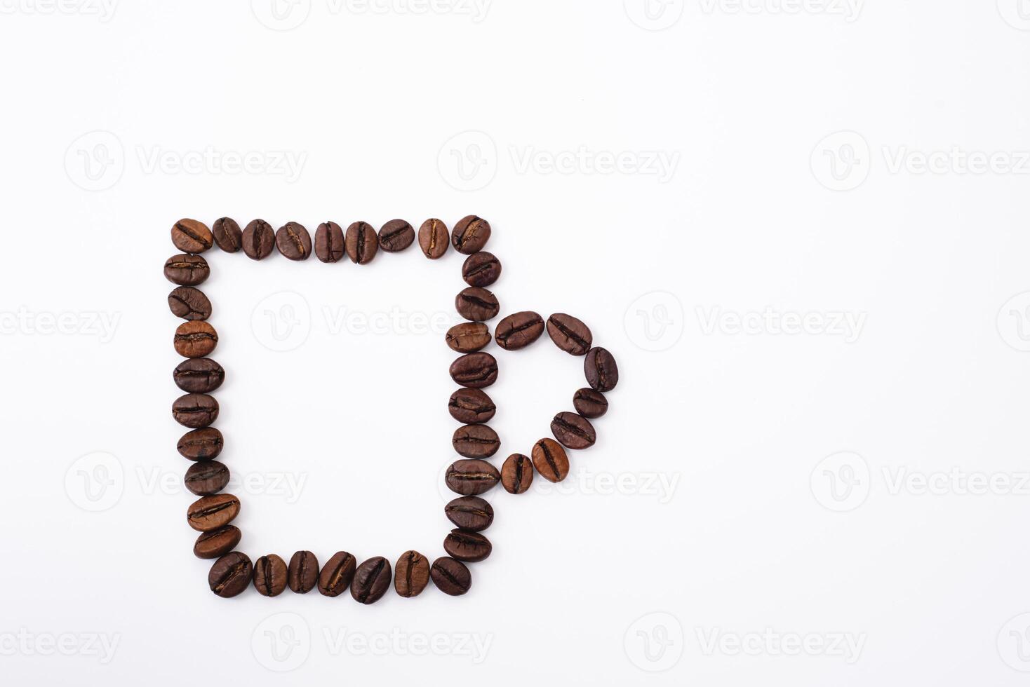 Coffee cup with foam made from coffee beans isolated on white photo