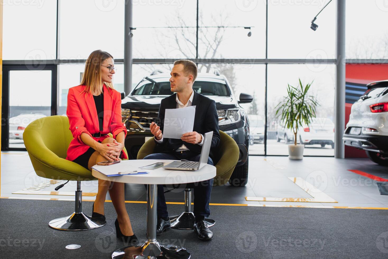 business woman buys a car at a car dealership. Concept of happy business people photo