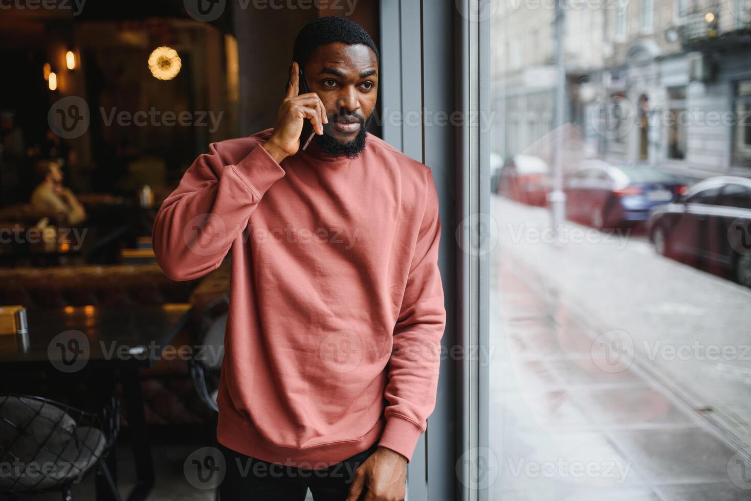 mature african american man talking by phone in cafe. photo