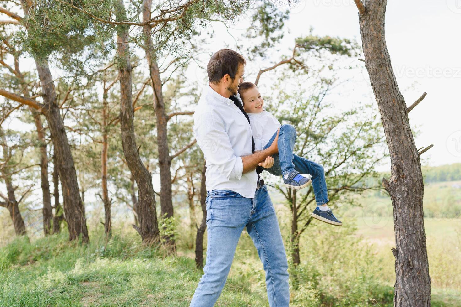 father and son have fun together in nature. Father and son playing. People having fun outdoors. Concept of friendly family. photo