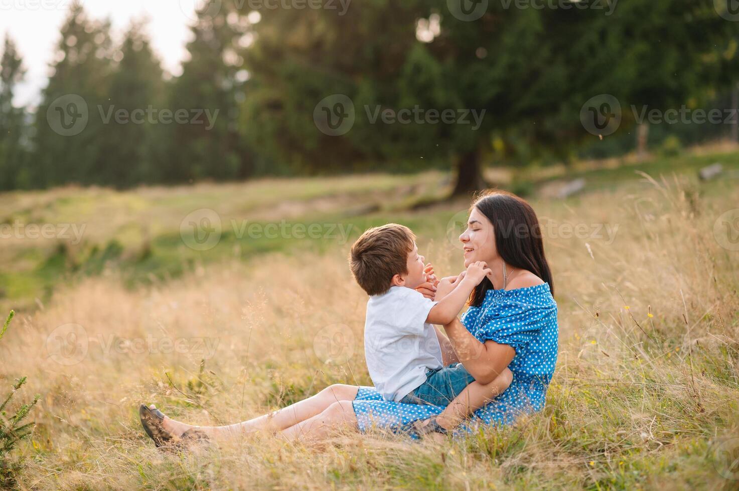 mother and son having rest on vacation in mountains. photo