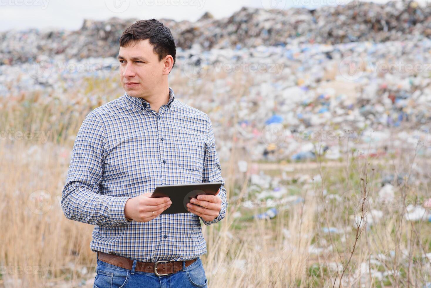 Environmental activist near the landfill. Keeping the environment clean. Ecological problems. Recycling photo