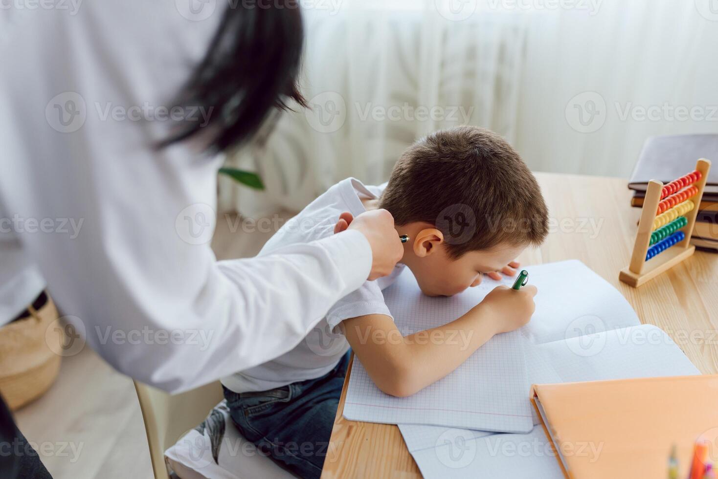 Happy teacher giving smiling girl private lessons after school photo