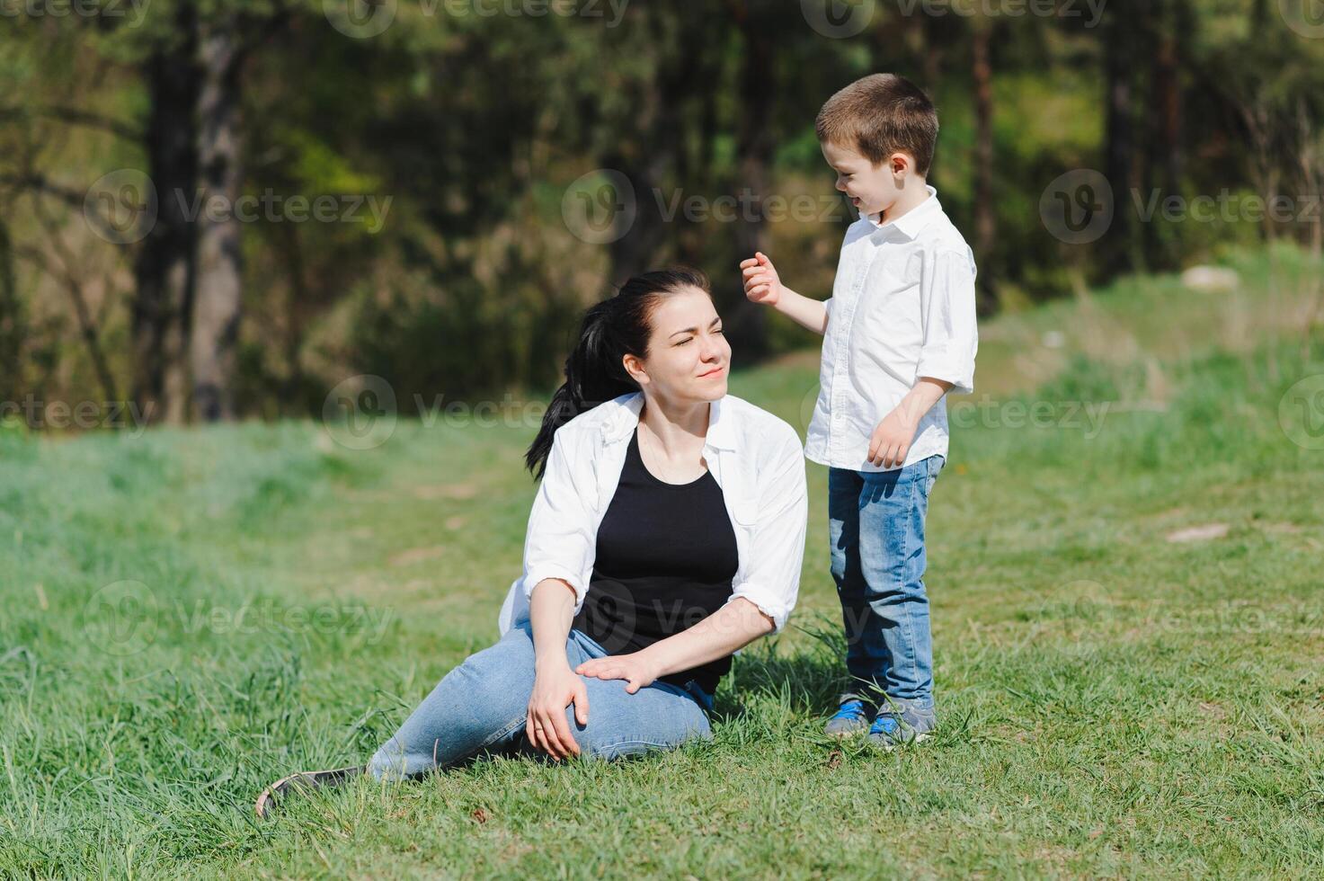 Stilish mother and handsome son having fun on the nature. Happy family concept. Beauty nature scene with family outdoor lifestyle. Happy family resting together. Happiness in family life. Mothers day. photo