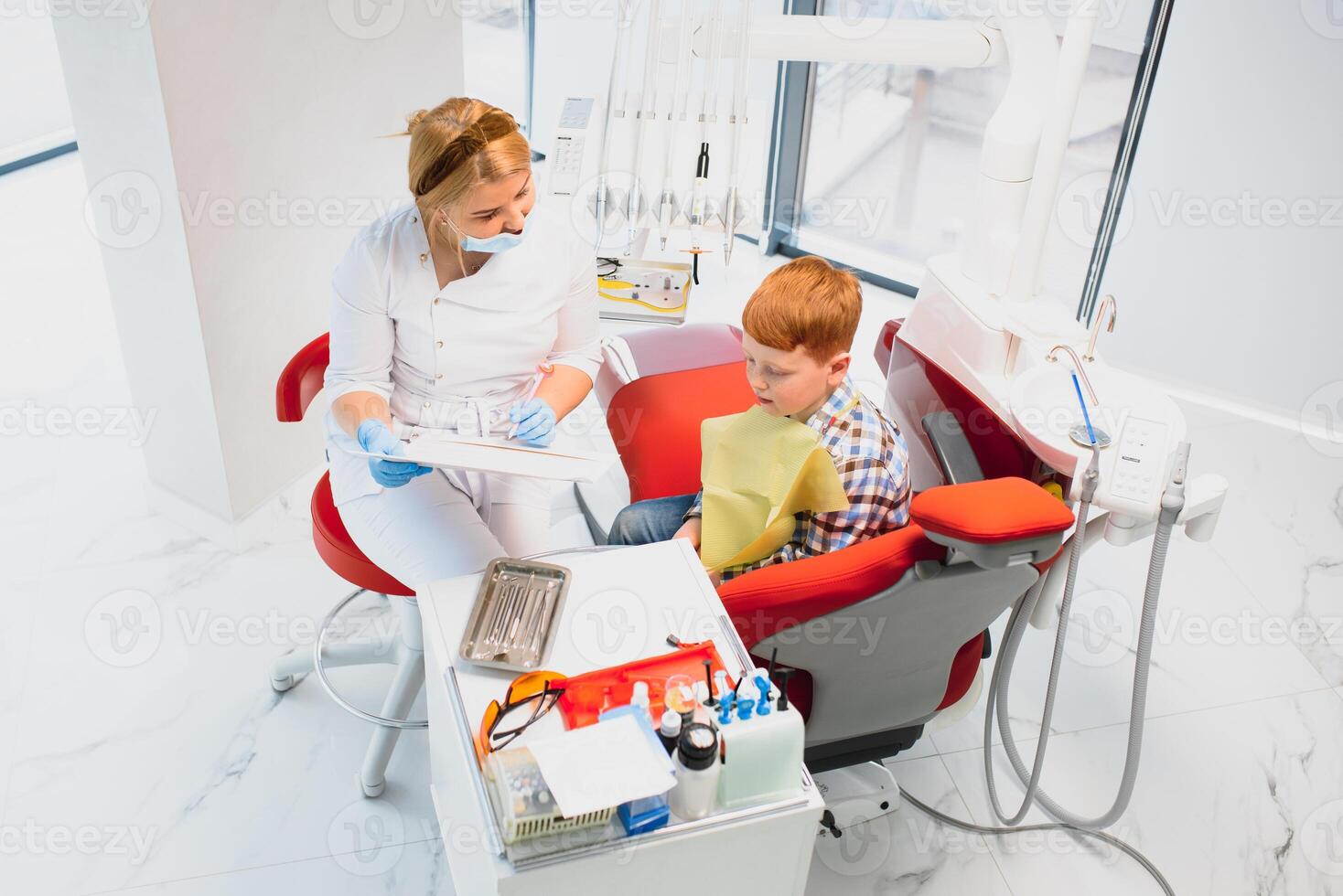 Boy satisfied with the service in the dental office. concept of pediatric dental treatment photo