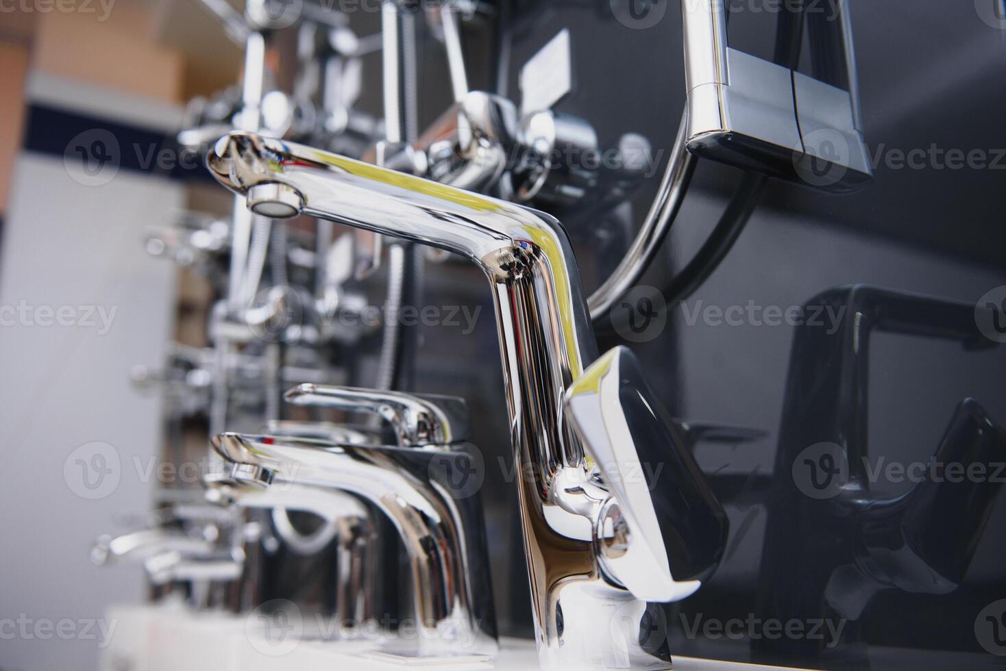 Rows of new faucets in plumbing shop, closeup photo