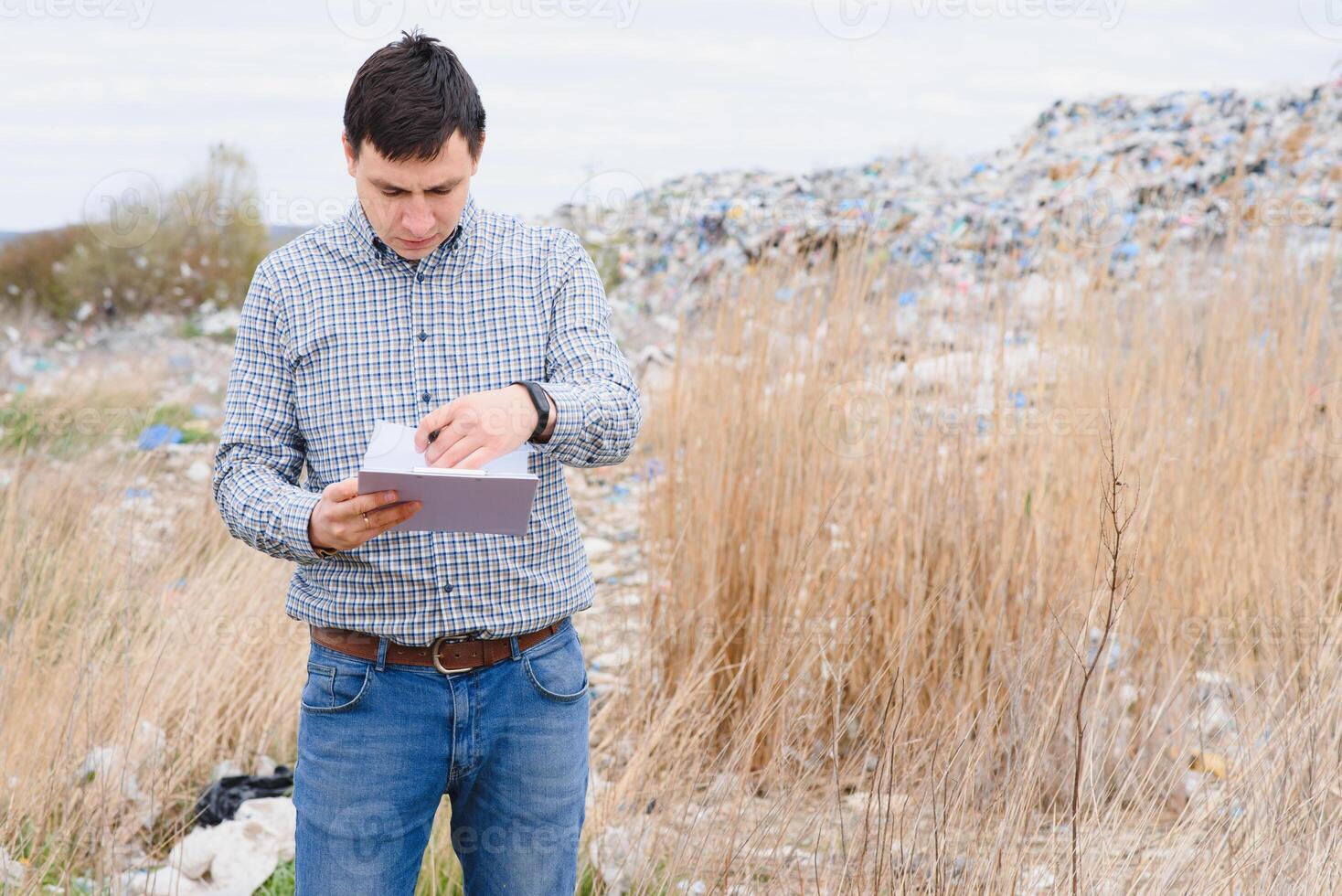 Nature conservation concept. A man studies the pollution of nature. Keeping the environment clean. Ecological problems. Recycling photo