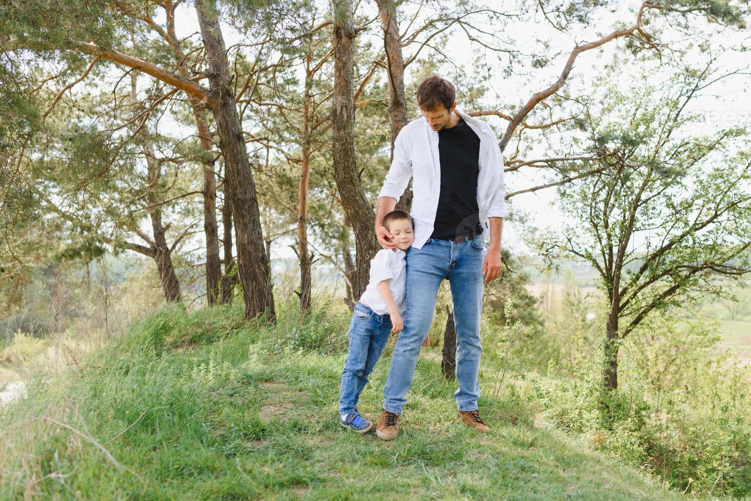 Happy time with father. Family fun concept. Bearded man and cute son Kids smile. Spring time walk with father. photo