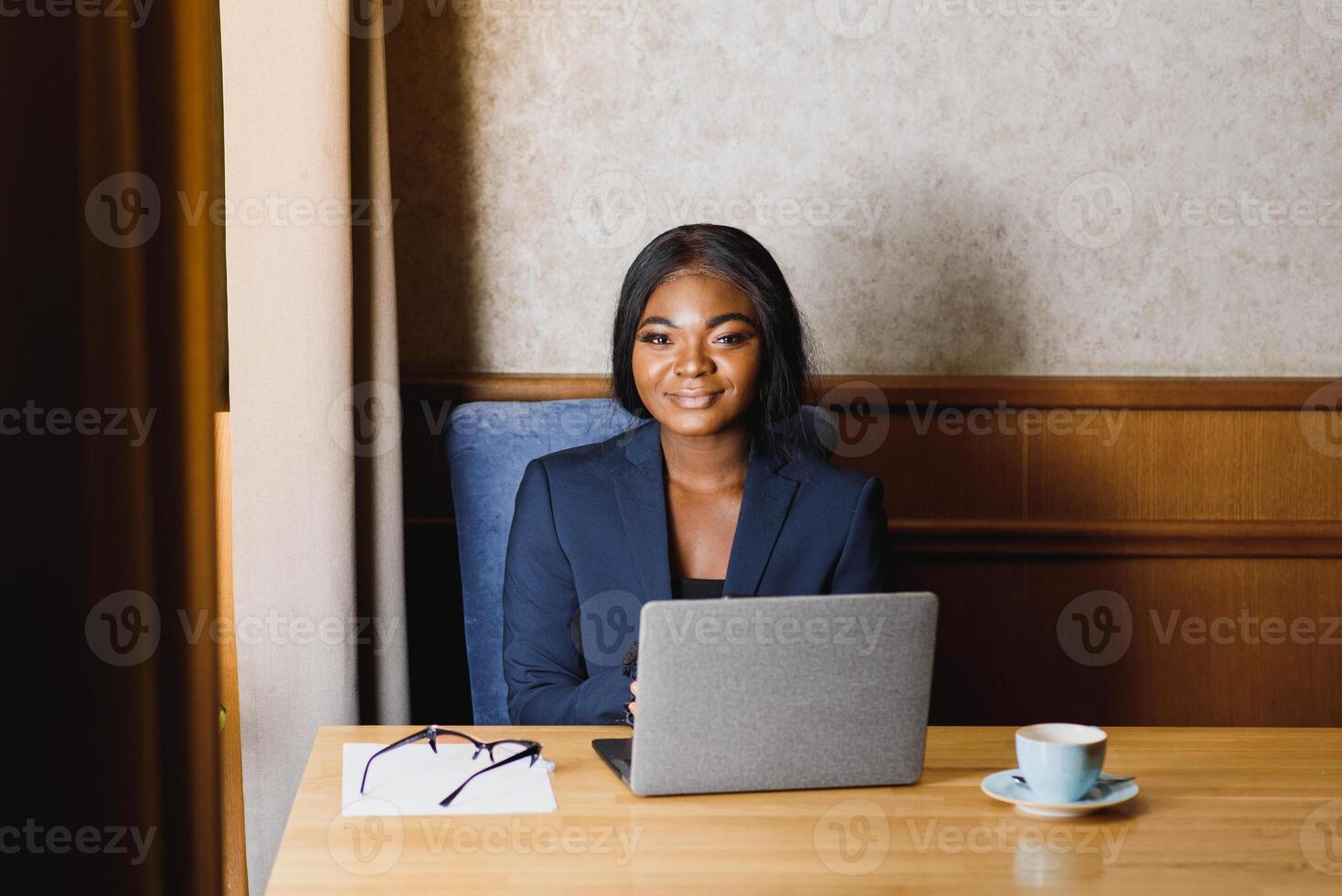 happy young african american businesswoman using computer in office photo