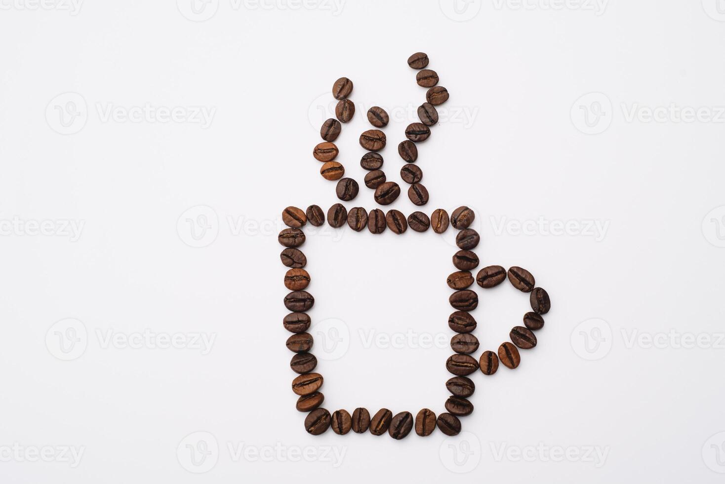Coffee cup with foam made from coffee beans isolated on white photo