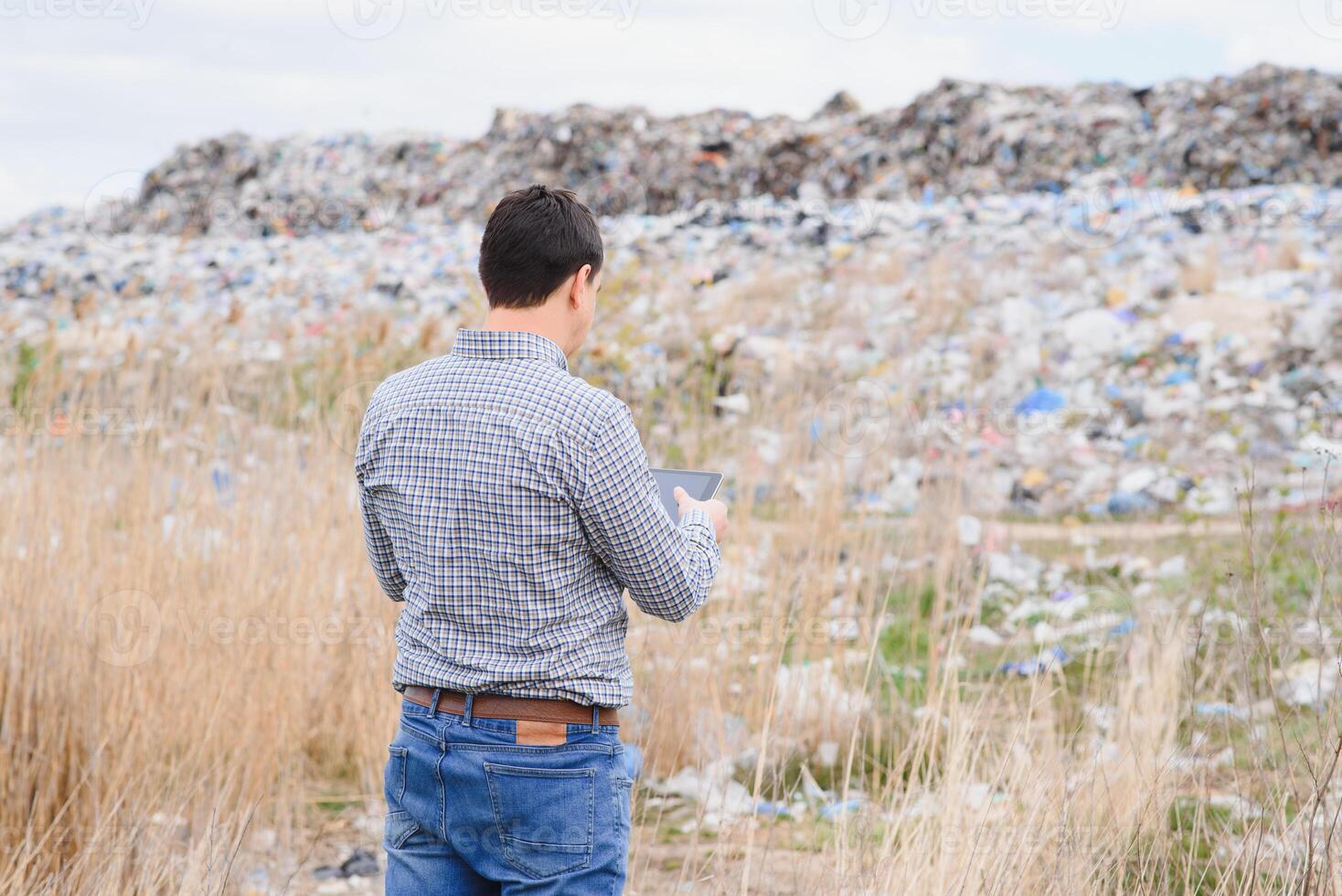 Nature conservation concept. A man studies the pollution of nature. Keeping the environment clean. Ecological problems. Recycling photo