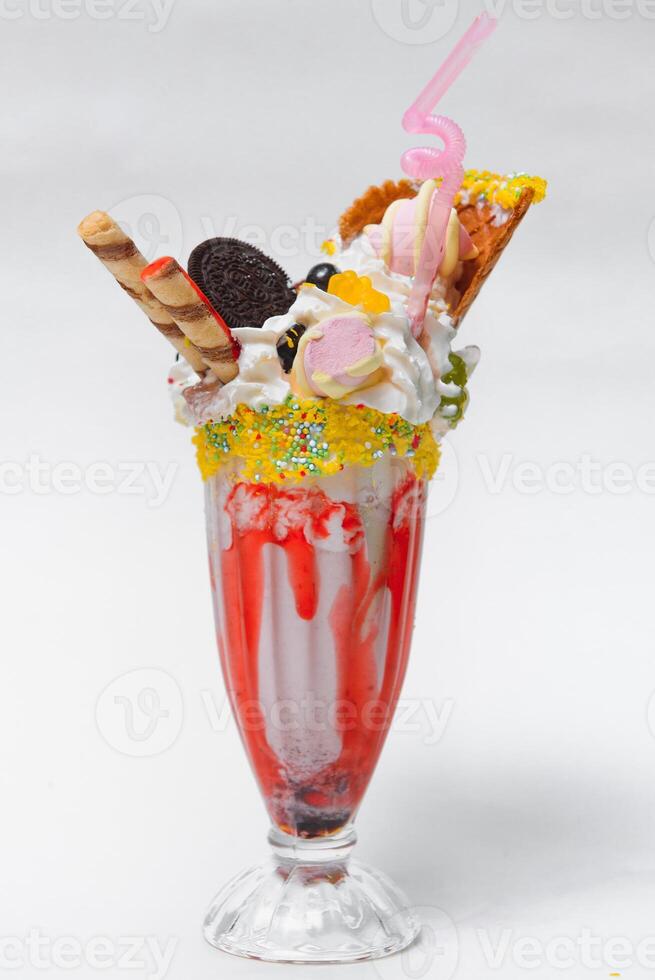 Ice cream with whipped cream, with waffles, cookies, candy photo