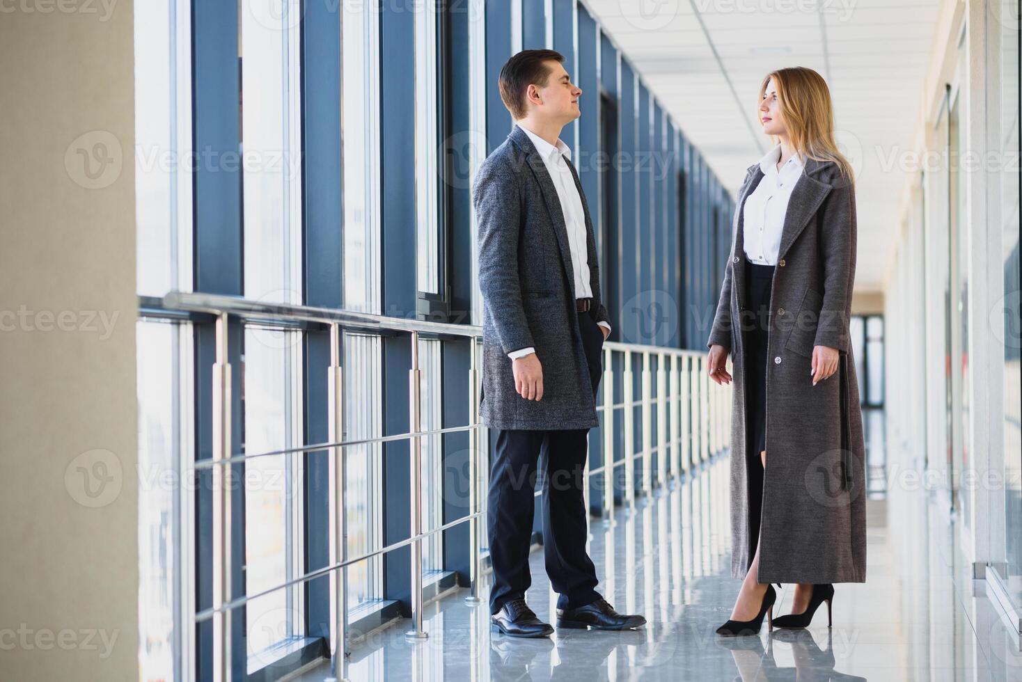 The business people walk in the office hall photo