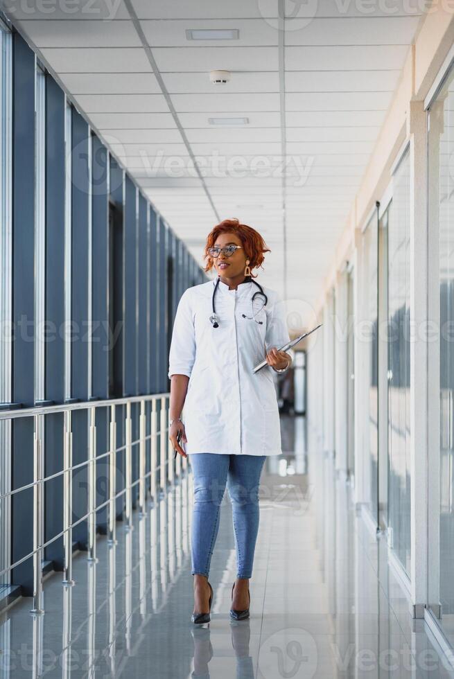 portrait of pretty african medical doctor. african american doctor in modern clinic photo