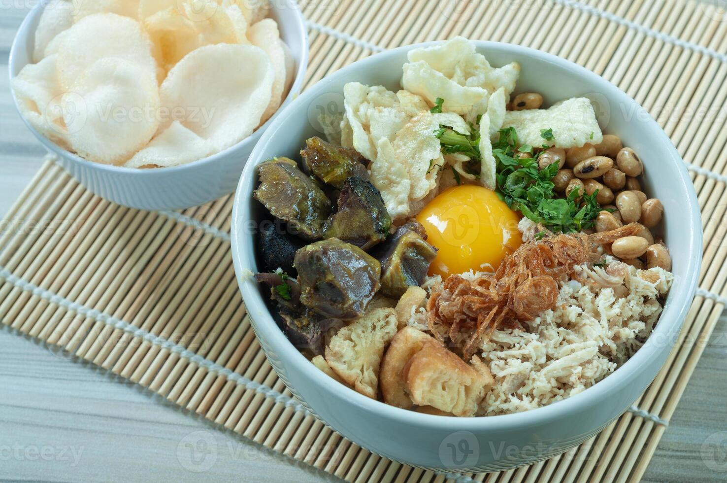 Bubur Daging Spesial or Special Meat Porridge contains white rice with side dishes of grilled beef slices photo