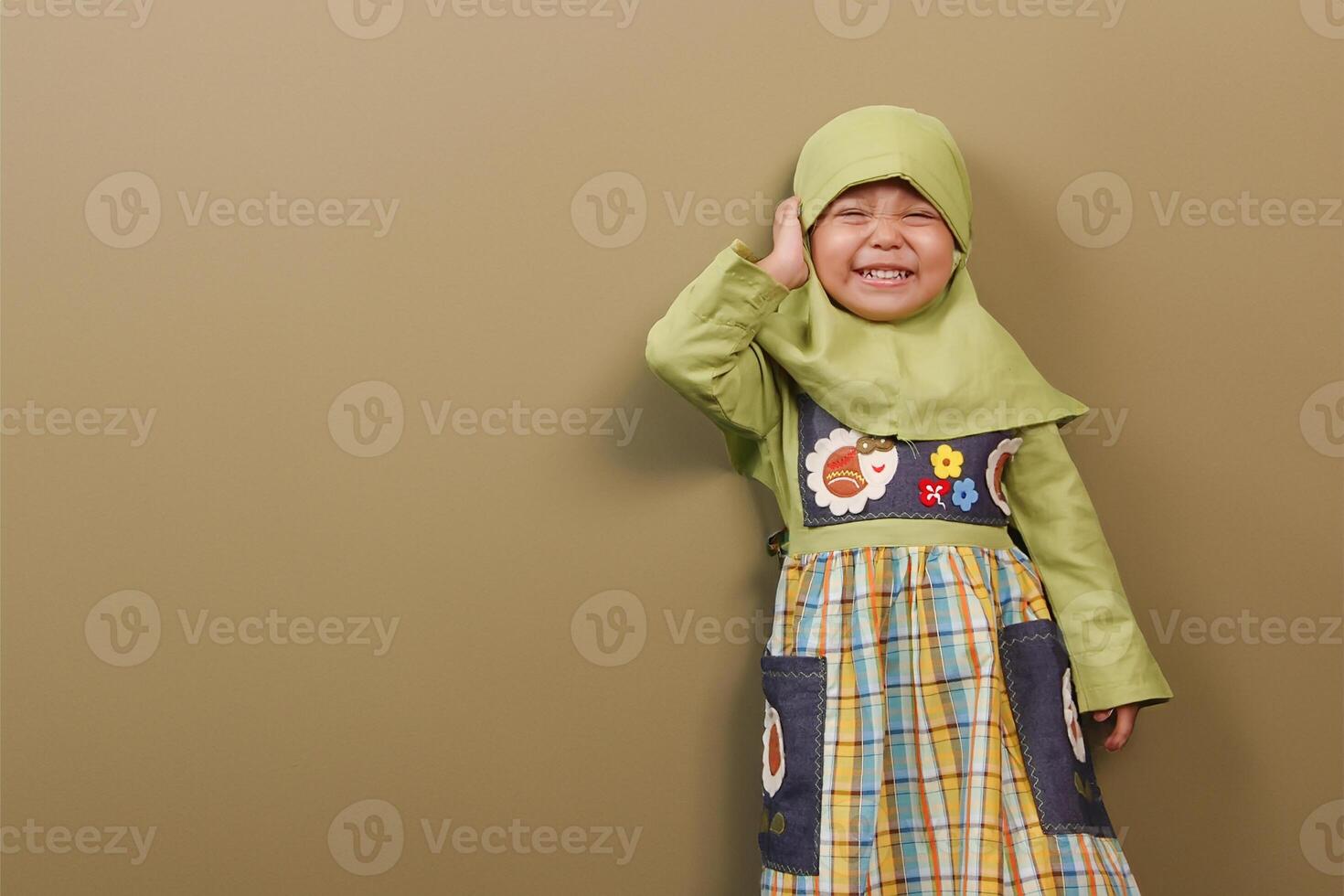 An Indonesian Little girl wearing hijab cloth very excited photo