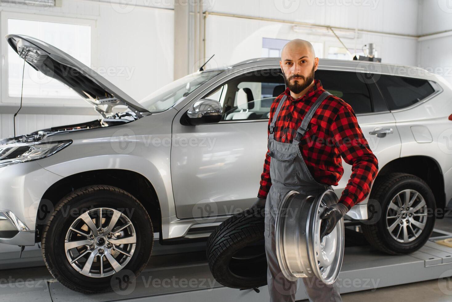 Mechanic working and holding wrench of service order for maintaining car at the repair shop photo