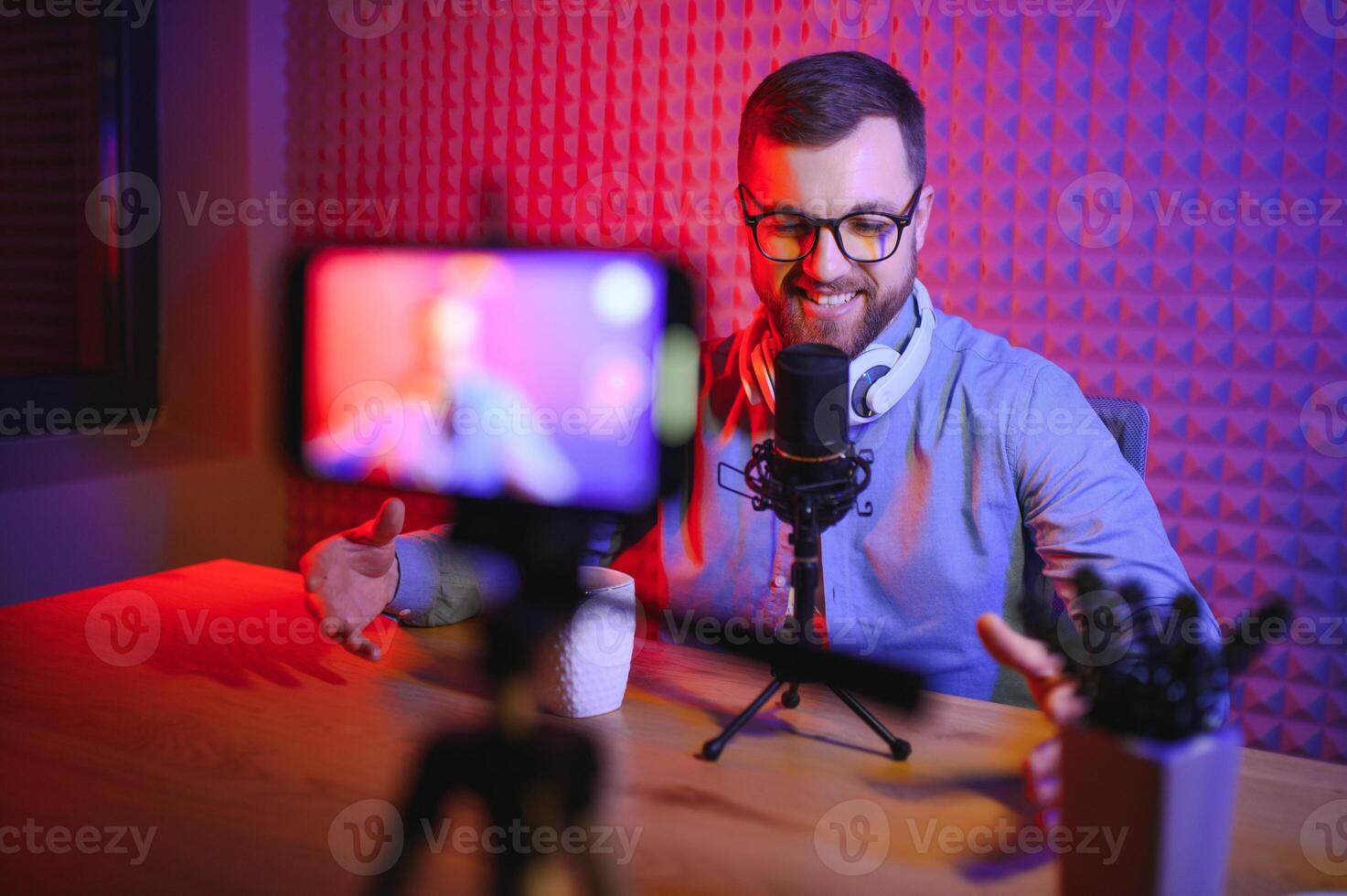 A video blogger records content in his studio. The backstage photo was taken from behind one of the participants in the shooting, at the beginning of the shooting when the blogger is preparing.