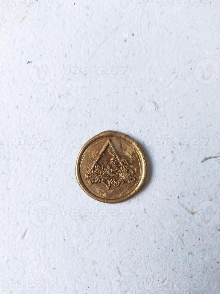 one vintage wax coin on a light background photo