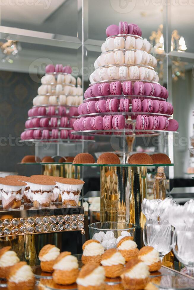 Delicious sweets on candy buffet. Table with sweets, buffet with cupcakes, Macaroons, candies, dessert photo