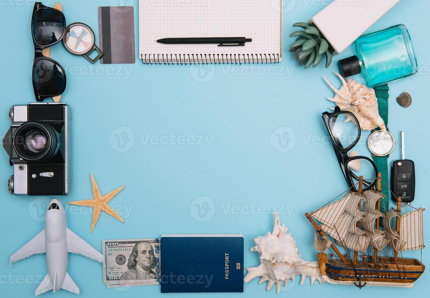 Preparation for Traveling concept, watch, airplane, money, passport, pencils, book, Photo frame, eyeglass on blue background with copy space.