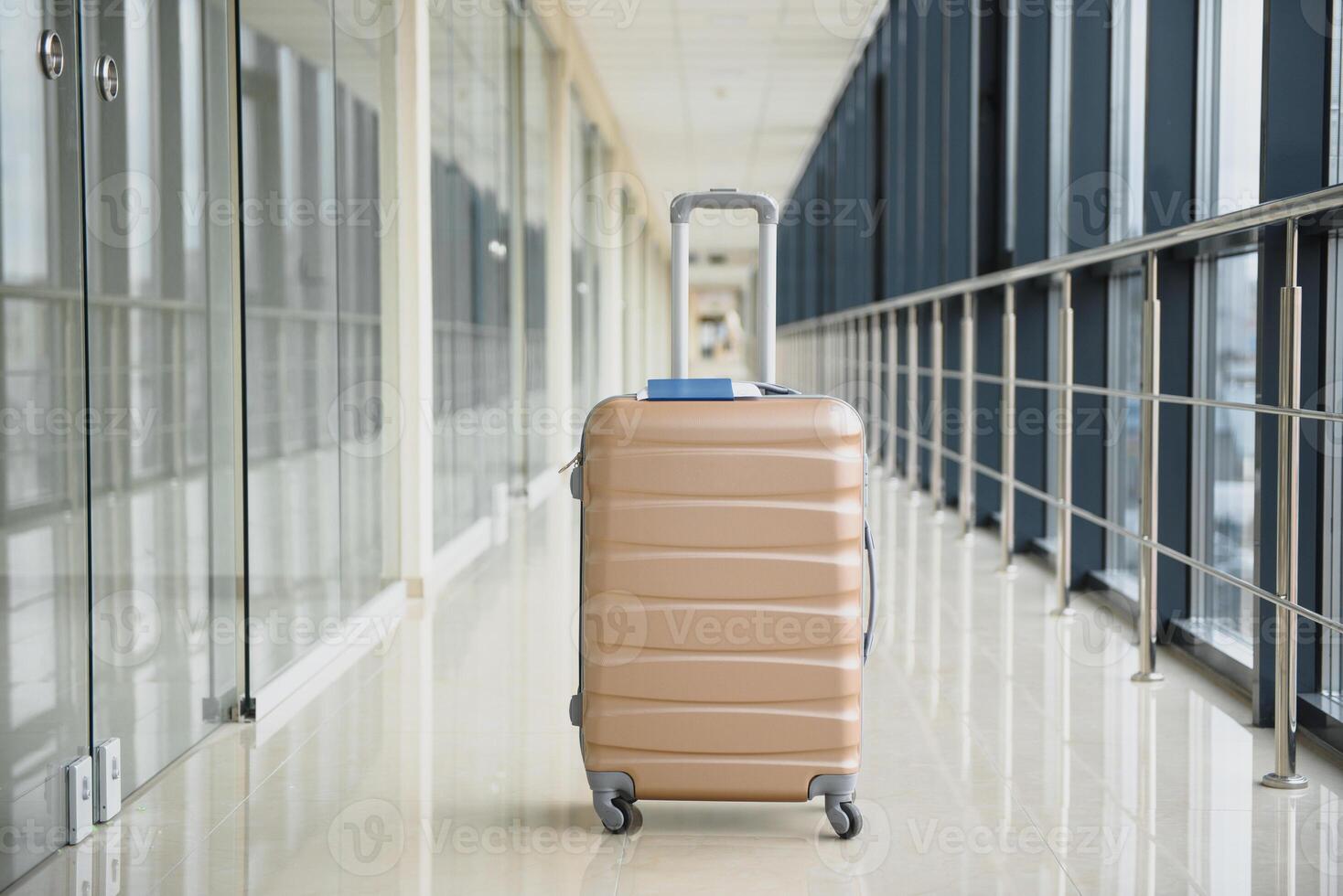 Suitcases in airport departure lounge, summer vacation concept, traveler suitcases in airport terminal waiting area, empty hall interior with large windows. luggage on airport terminal background. photo