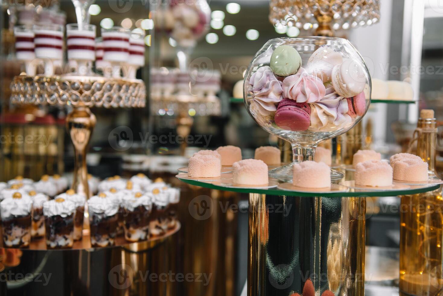 Delicious sweets on candy buffet. Table with sweets, buffet with cupcakes, Macaroons, candies, dessert photo